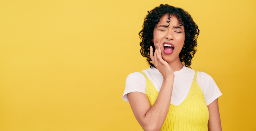 Teeth, problem and woman in studio with toothache, pain or cavity on yellow background. Dental, emergency or female model with broken tooth, inflammation or gum disease, decay or nerve, jaw or injury